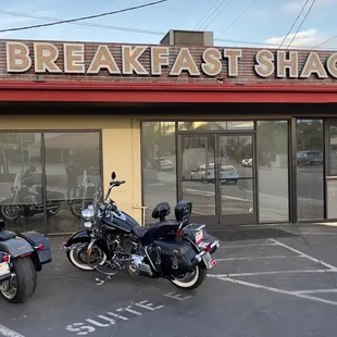two motorcycles parked in front of the restaurant