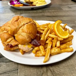 TBA, Turkey, bacon, Avocado, cheese and lettuce on a croissant, it was good.  The fries were crispy and also good.