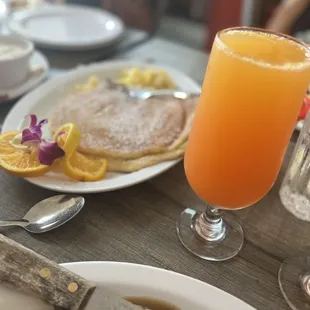 Delicious pancakes with powder sugar and mimosa