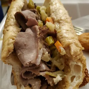 a sandwich with meat and vegetables