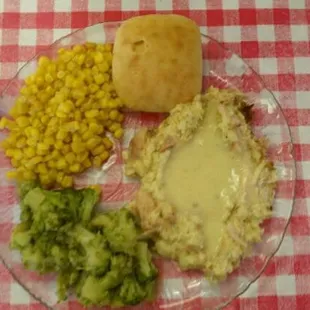 Chicken &amp; dressin&apos;, broccoli, corn, &amp; a roll.