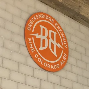 a brick wall with a logo on it