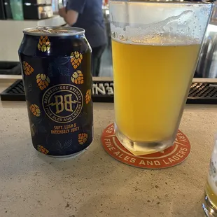 a glass of beer and a can of beer