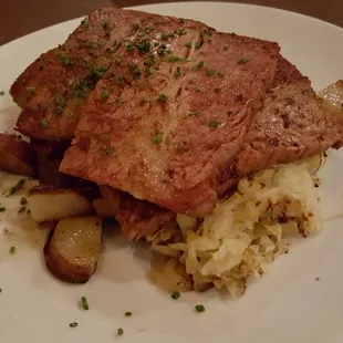 Corned beef with sauerkraut &amp; fried potato slices.