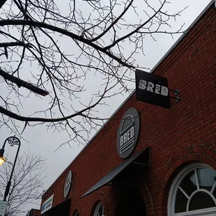 a brick building with a street sign in front of it