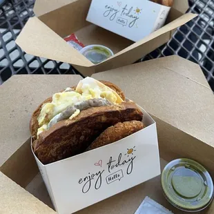 Sausage egg and cheese sandwich with a hash brown and side sauce