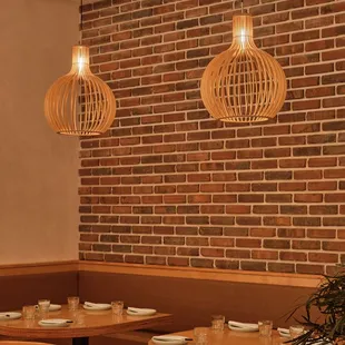 a dining area with a brick wall