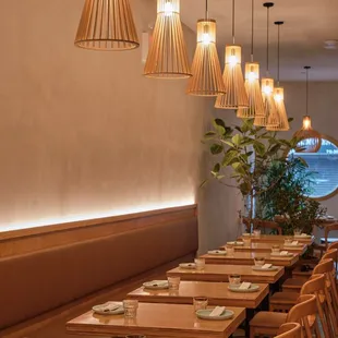 a dining area with wooden tables and chairs