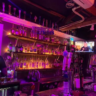 a bar filled with bottles of alcohol