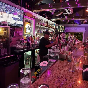 a man behind the bar at a sports bar