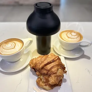 a croissant and a cup of coffee