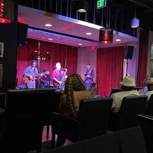 a group of people sitting in front of a stage