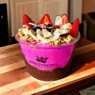 a smoothie with strawberries, bananas, and granola