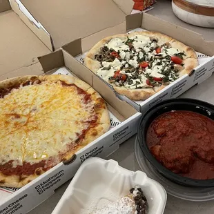 pizzas and condiments on a table