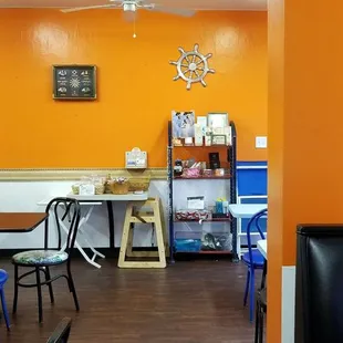 a dining room with orange walls