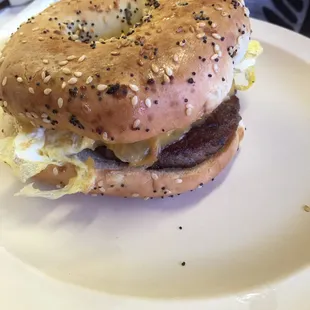 Everything bagel breakfast sandwich - scrambled eggs, American cheese, sausage, on an everything bagel.