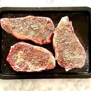 three steaks in a pan