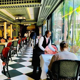 Main dining room faces the courtyard floor to ceiling glass giving a Atrium effect. Lots of natural light. Beautiful space 4 brunch.