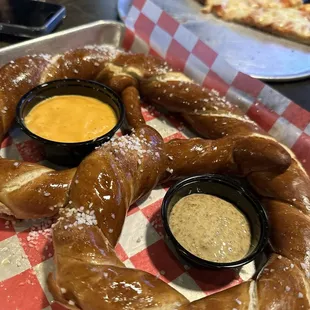Jumbo pretzel and cheese pizza in the background