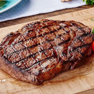 a steak on a wooden cutting board