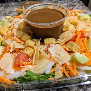 Large house salad with housemade balsamic vinaigrette. Romaine, cucumbers, carrots, tomatoes, onions, Parmesan, croutons. $6.49.