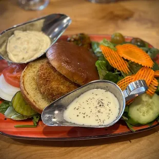 a plate of food with a sandwich and salad