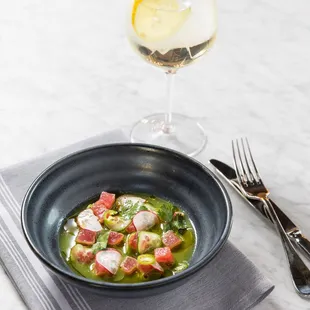 a bowl of soup and a glass of wine