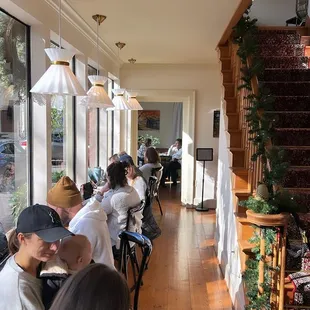 people sitting at tables in a cafe
