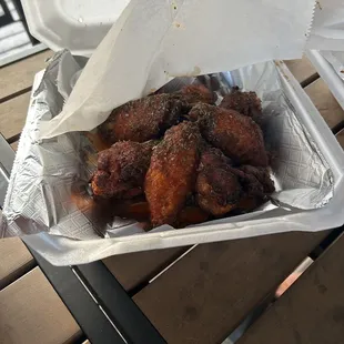 chicken wings in a foil container