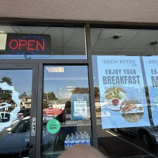 The open sign shows the brew bytes cafe is open and serving the special seasonal lattes