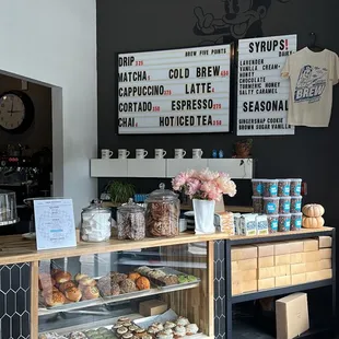 a coffee shop counter with a variety of pastries