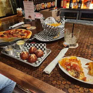 a table with pizza and beer