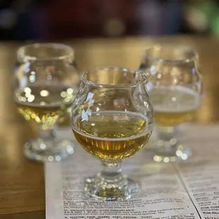 three glasses of beer on a table