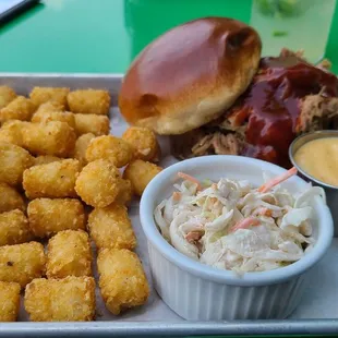 Pulled Pork with a side of Tarter Tots, cole slaw and a side of beer cheese