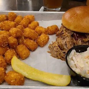 Excellent Pulled Pork Sandwich, slaw on the side, and tater tots.