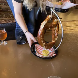 a woman holding a pretzel