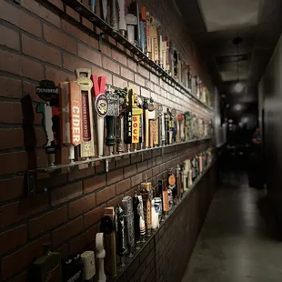 a long wall of beer bottles
