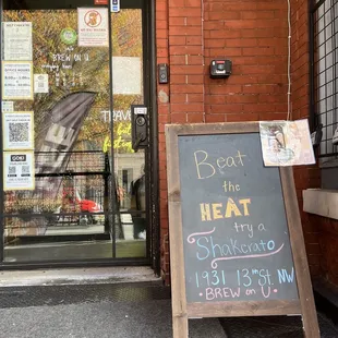 a chalk board outside of a coffee shop