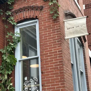 a brick building with a sign in the window