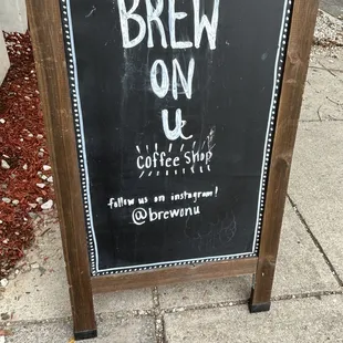 a chalkboard sign on a sidewalk