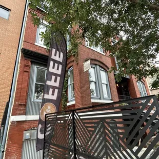 a sign in front of a brick building