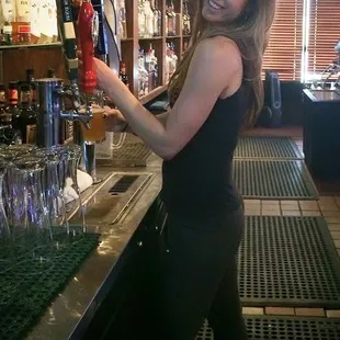 a woman pouring a beer