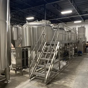 a row of stainless steel tanks