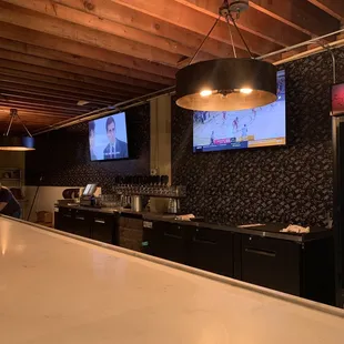 a bar with a television and a refrigerator
