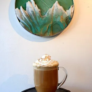 a cup of coffee with whipped cream on top