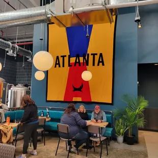 people sitting at tables in a coffee shop