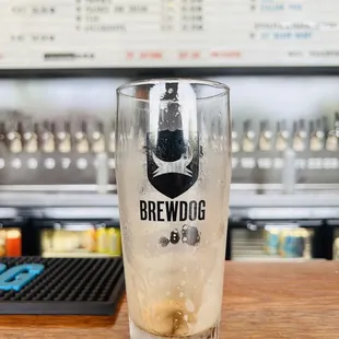 a glass of beer on a bar