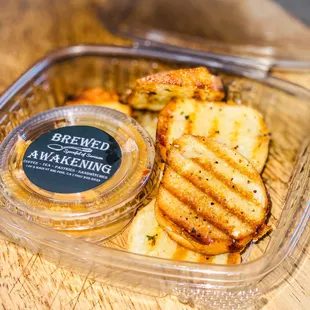 a container of bread and dipping sauce