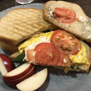 Vegetarian sunrise: Egg, fresh basil, garden tomato, and goat cheese, on perfectly toasted bakery fresh bread.