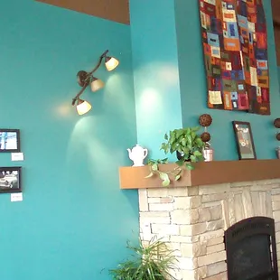 Cozy fireplace with comfy chairs. Changing art exhibits. Upright piano that gets played on some evenings.